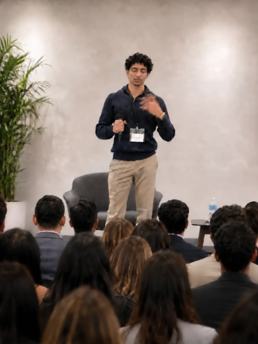 Aiden Muhammad speaking to a seated audience